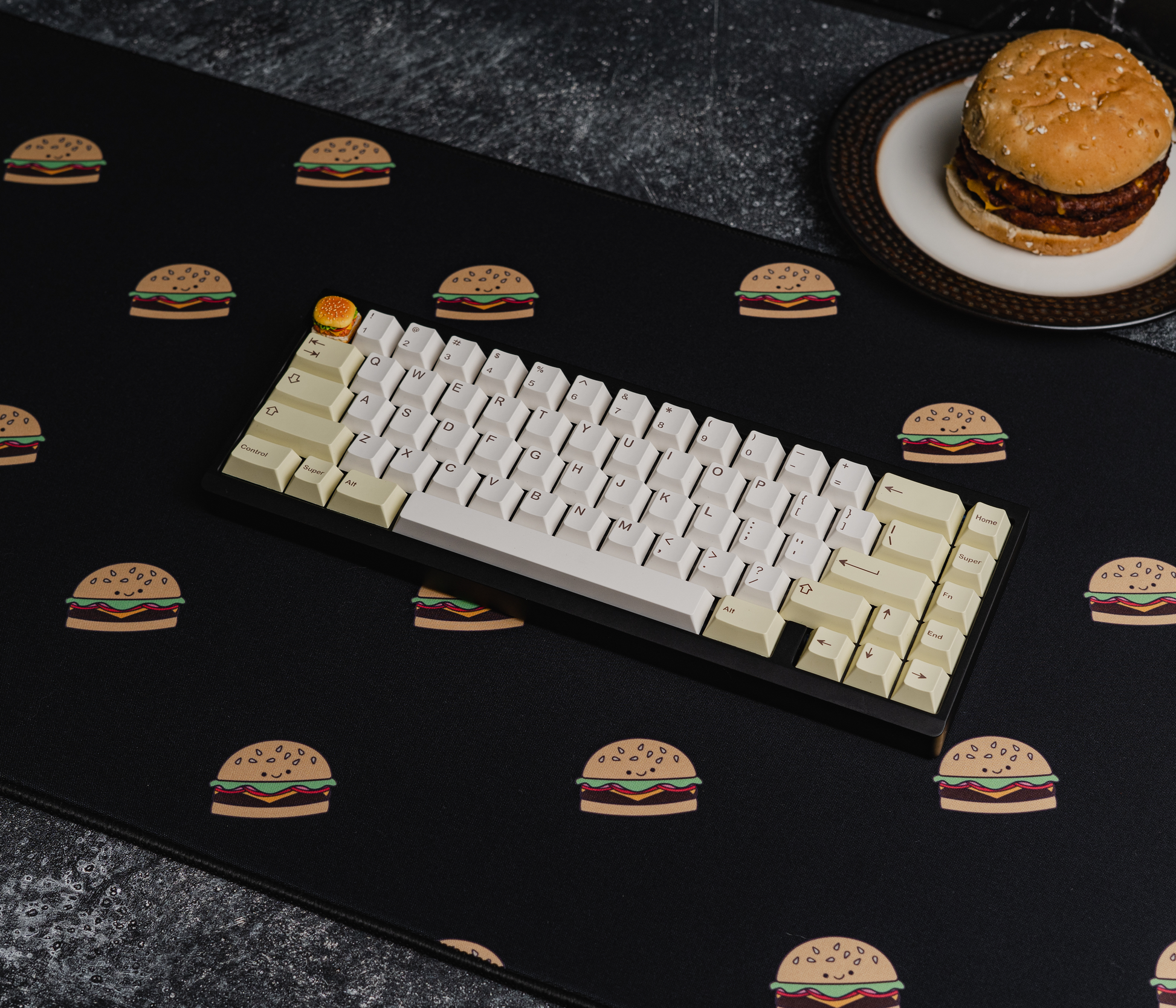 Burger-printed desk mat with black surface and scattered burger icons