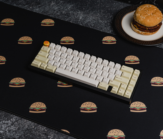 Burger-printed desk mat with black surface and scattered burger icons