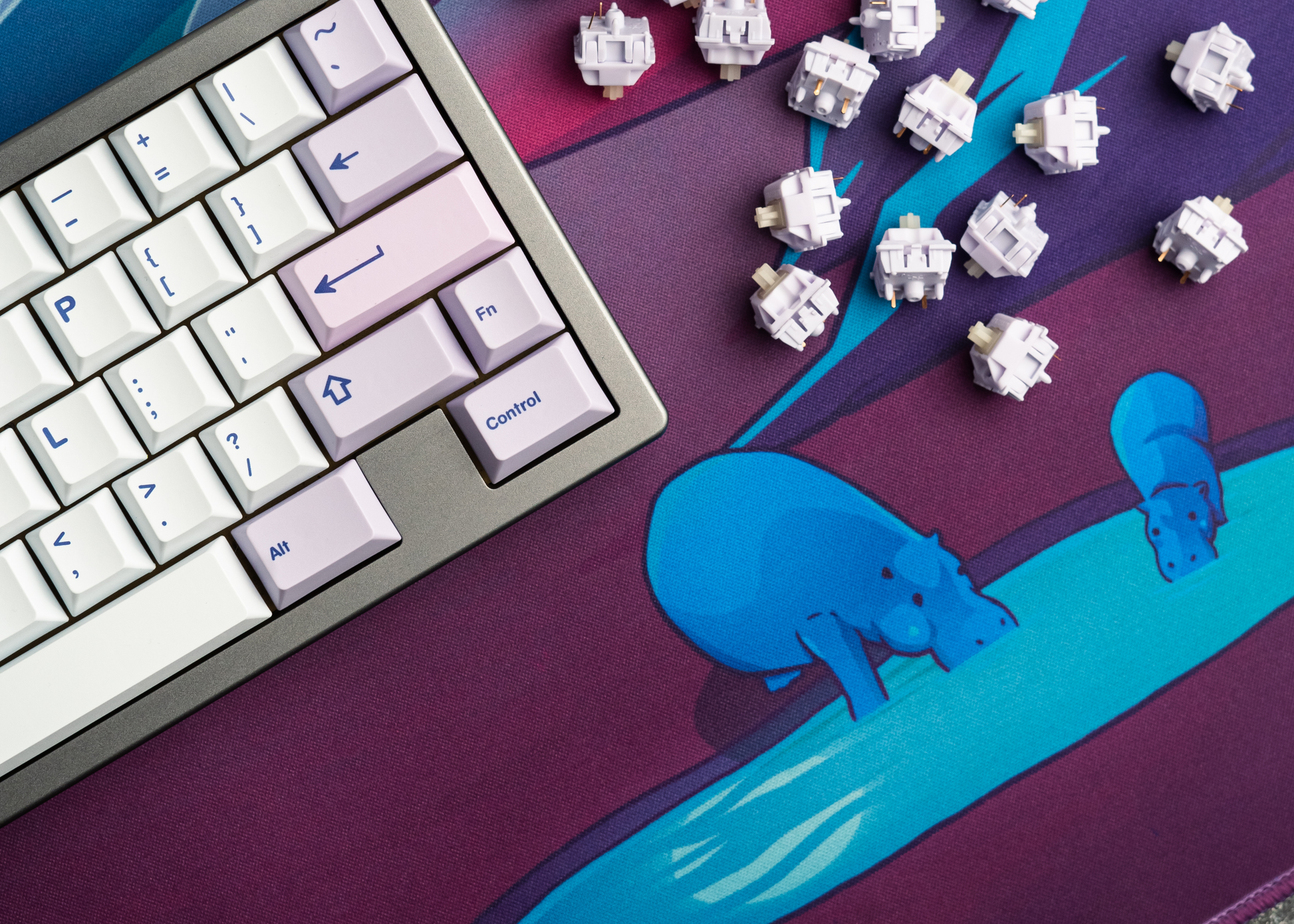 Desk mat with textured purple surface and neon blue creature silhouette