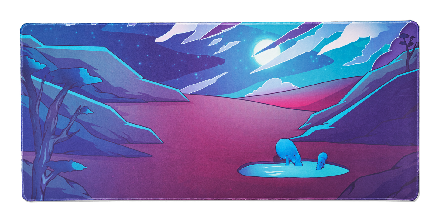 Desk mat with neon desert canyon scene, blue creatures in glowing pool