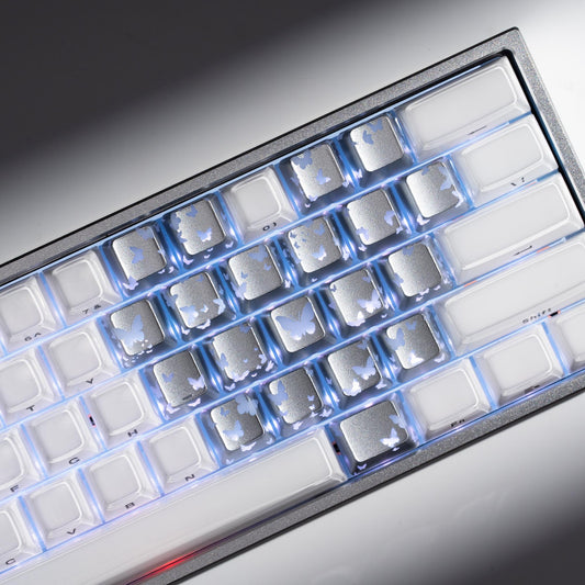 Silver-tone keyboard keycaps with backlit butterfly cutouts and square legends