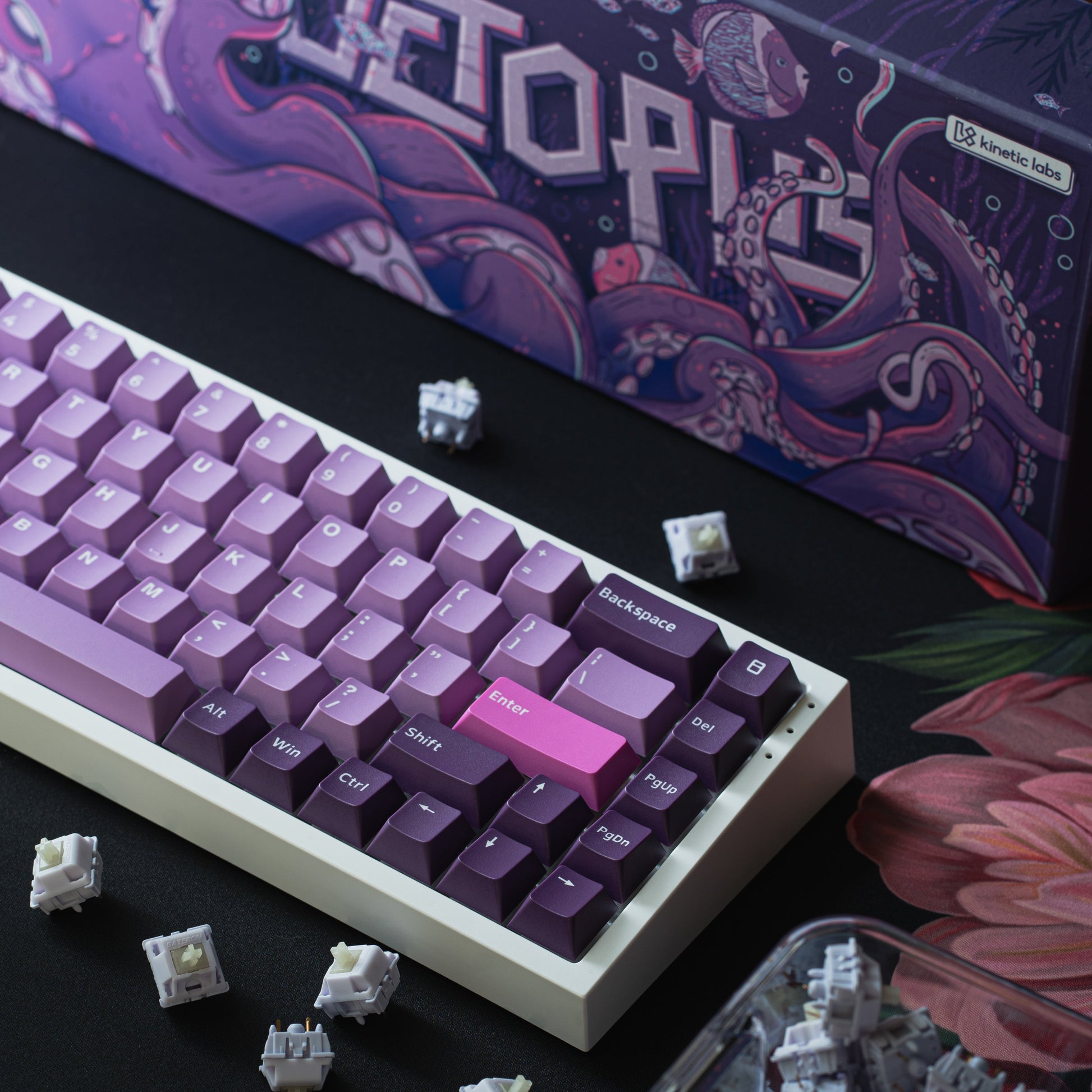 Octopus-themed purple keyboard keycaps with individual keycaps removed nearby.