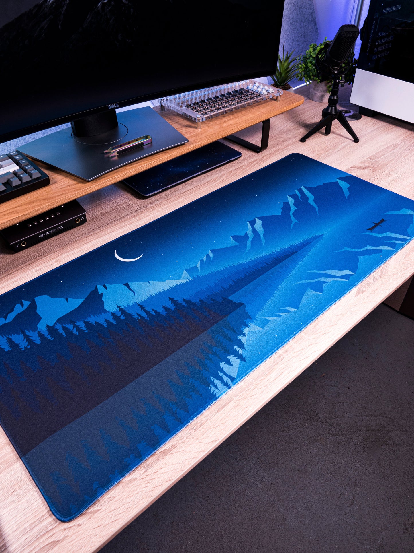 Alberta V2 desk mat with dark blue moonlit landscape print and airplane icons