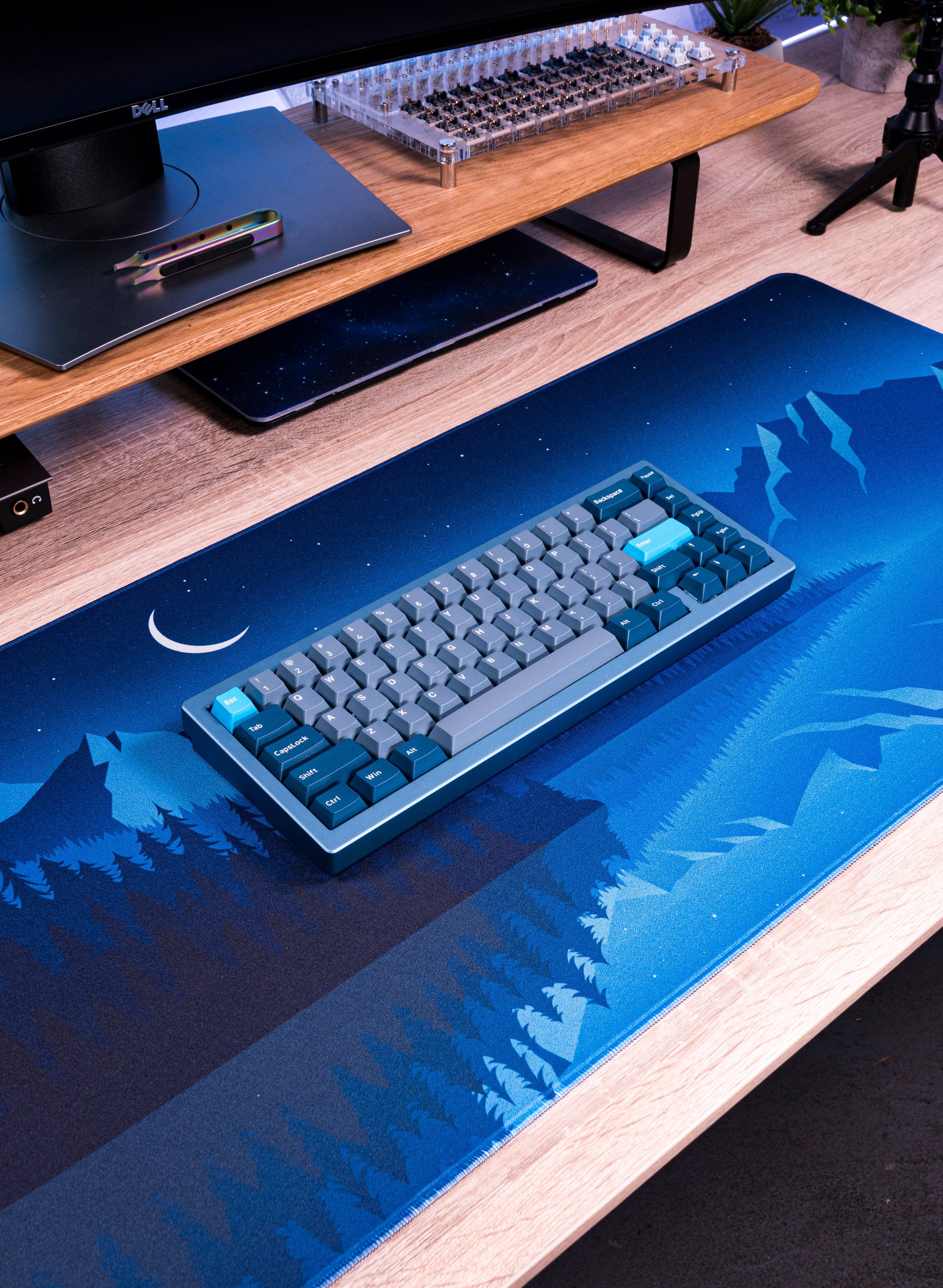 Alberta V2 desk mat with blue starry forest and mountains pattern under keyboard