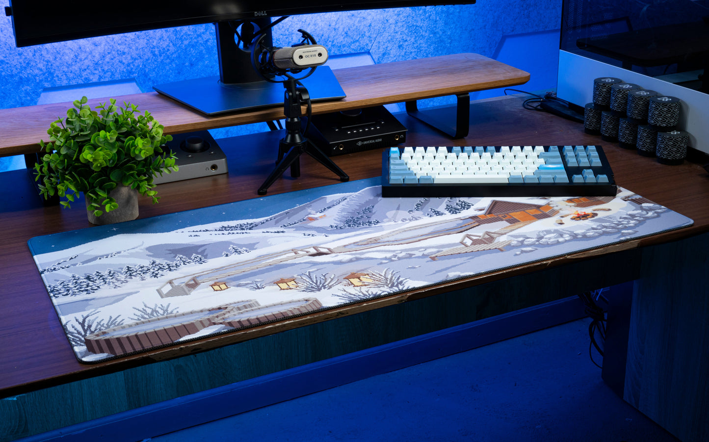 Winter desk mat with snowy cabin scene and trees across the surface.