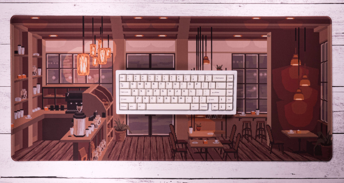 Coffee shop desk mat with white keyboard on top, framed café illustration
