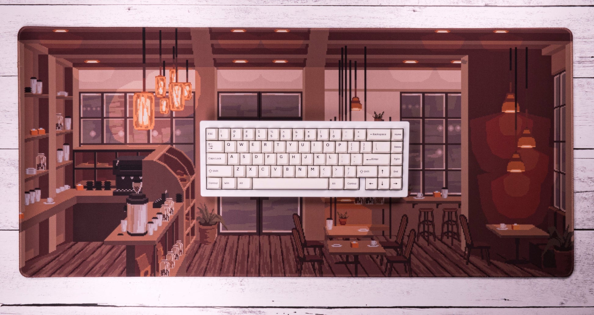Coffee shop desk mat with white keyboard on top, framed café illustration