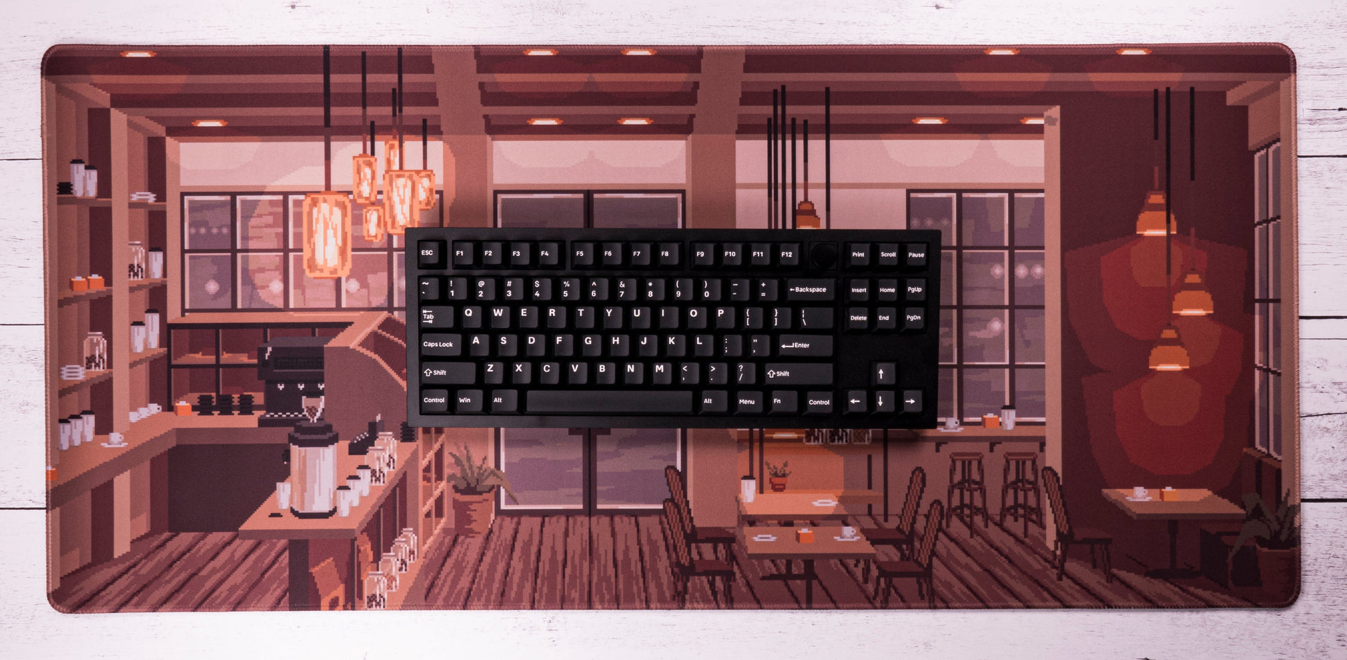 Coffee shop desk mat with black keyboard on top, wide café storefront artwork