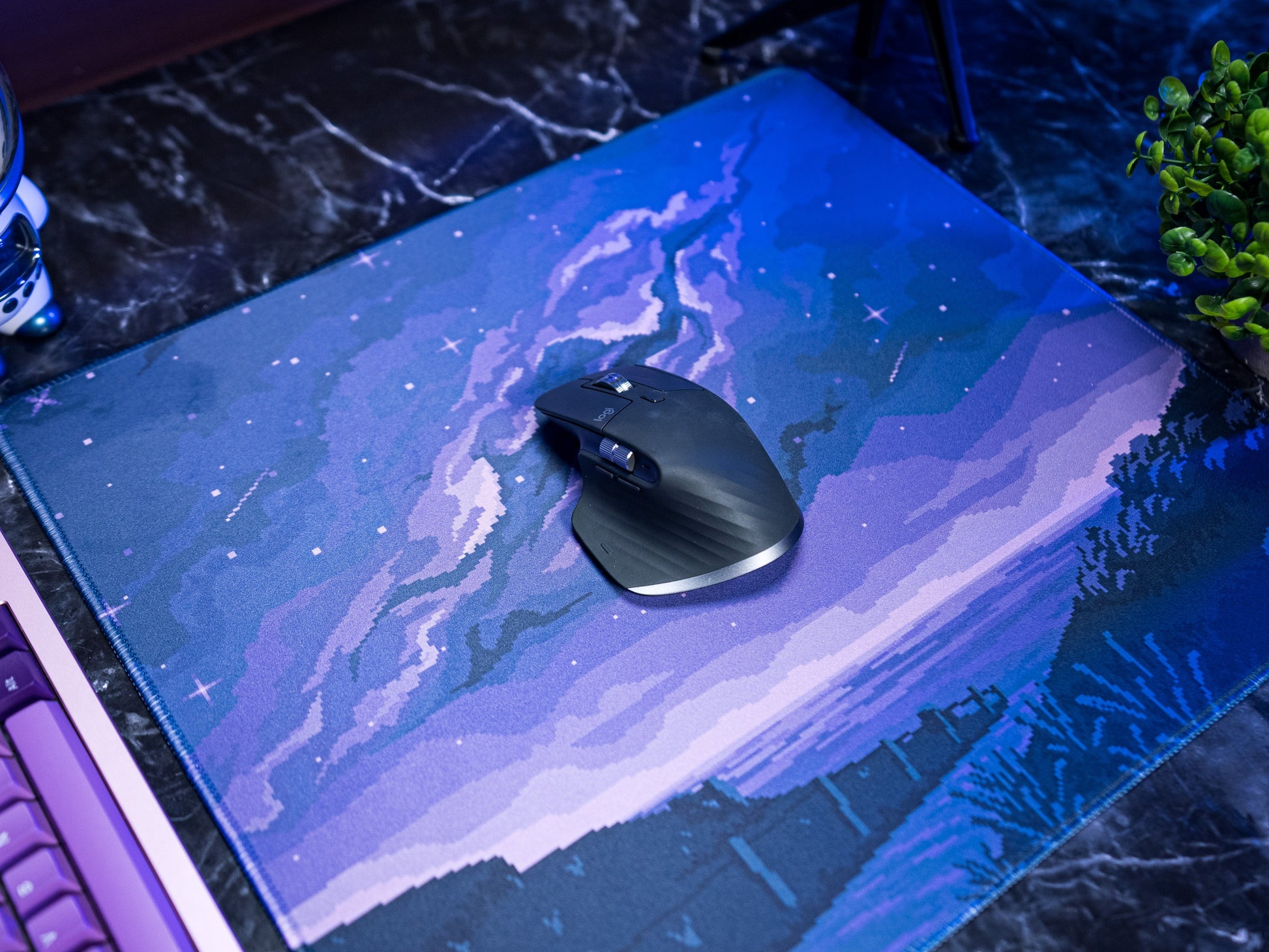 Blue-toned pixel desk mat with star speckles, hills, and winding trail