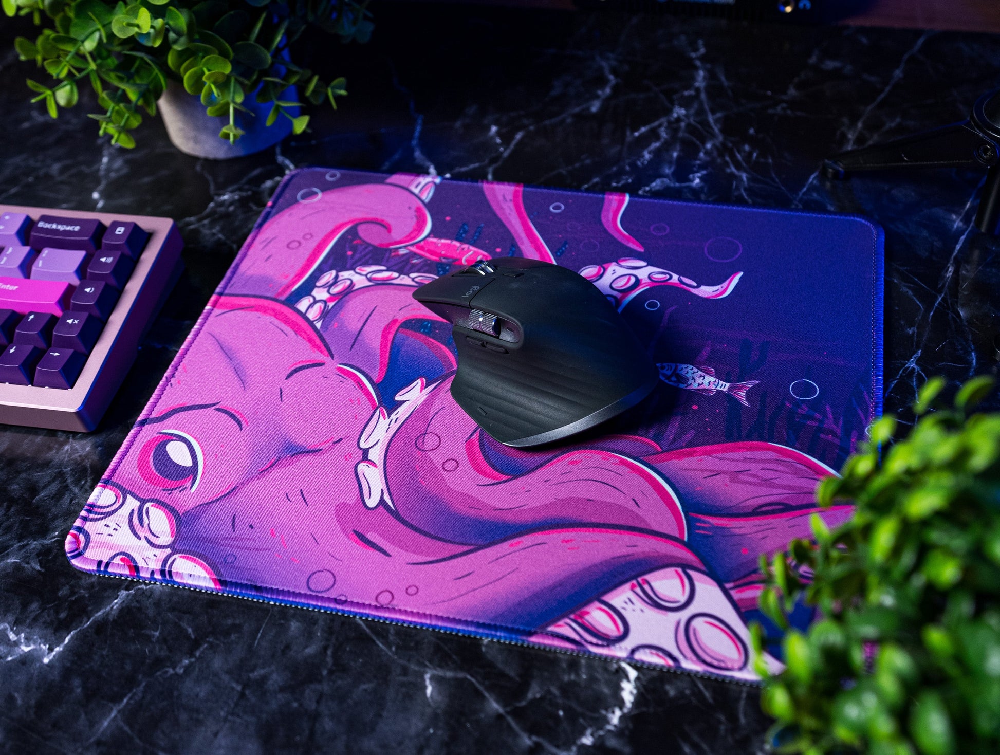 Octopus desk mat with pink octopus graphic and black mouse on top
