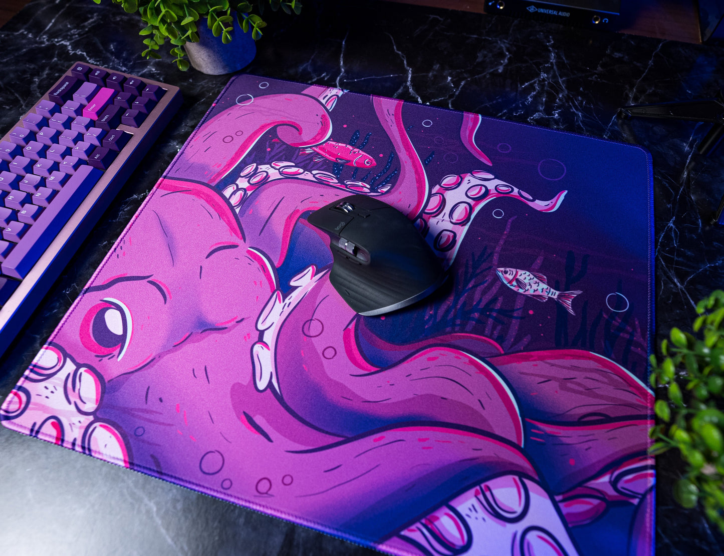 Octopus desk mat with pink octopus artwork and black mouse centered