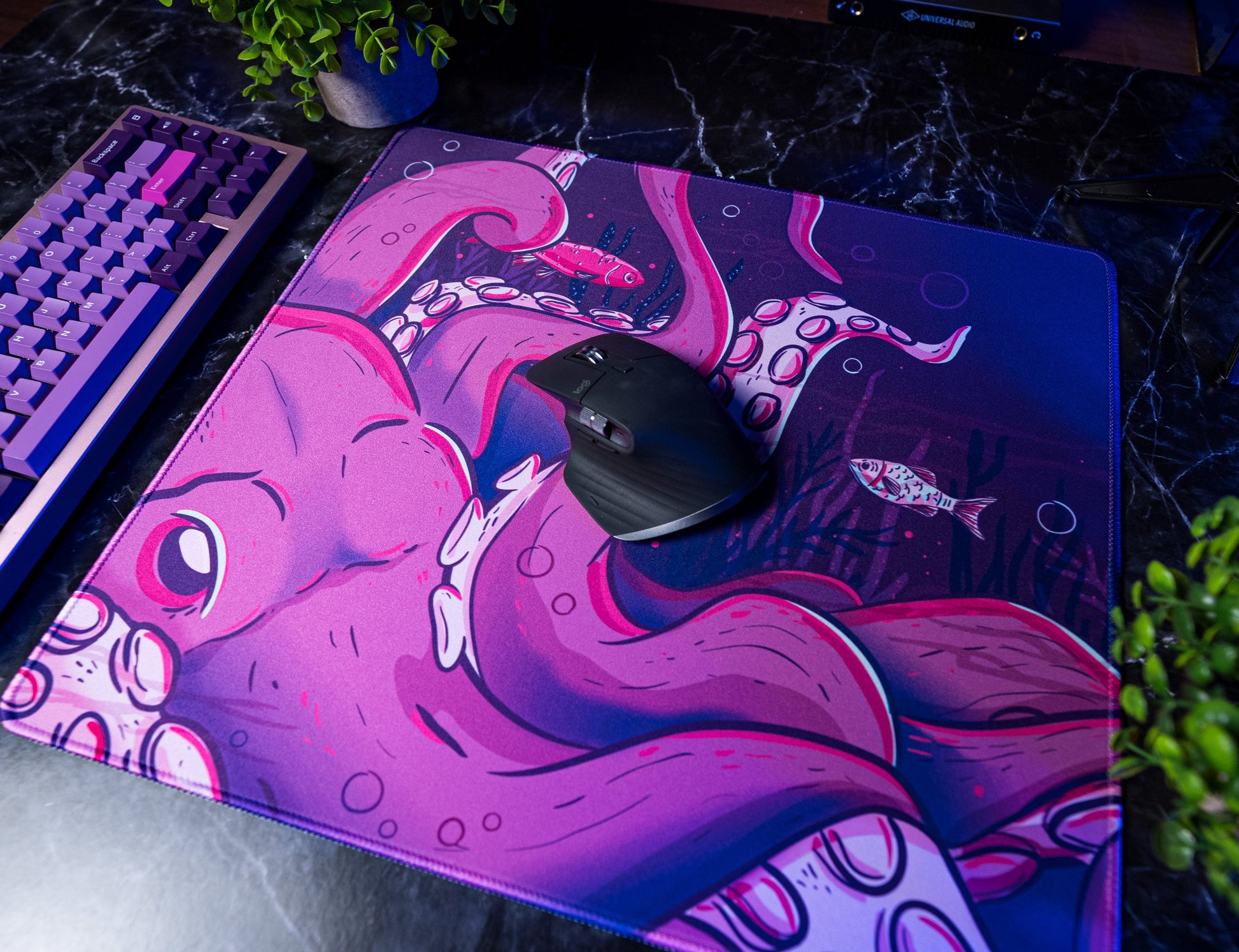 Octopus desk mat with pink octopus artwork and black mouse centered