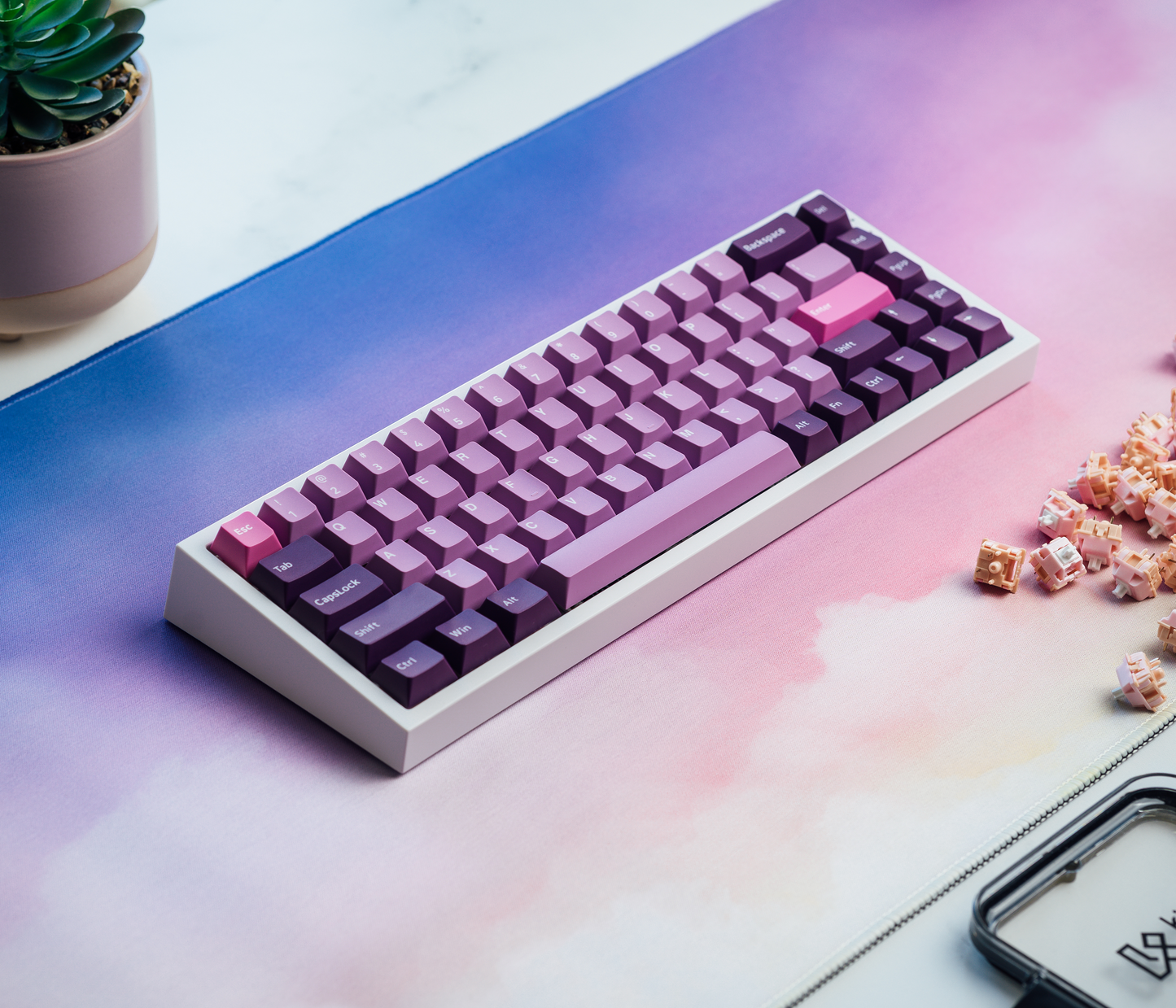 Desk mat under a keyboard, featuring pastel cloud gradient in blue, purple, and pink