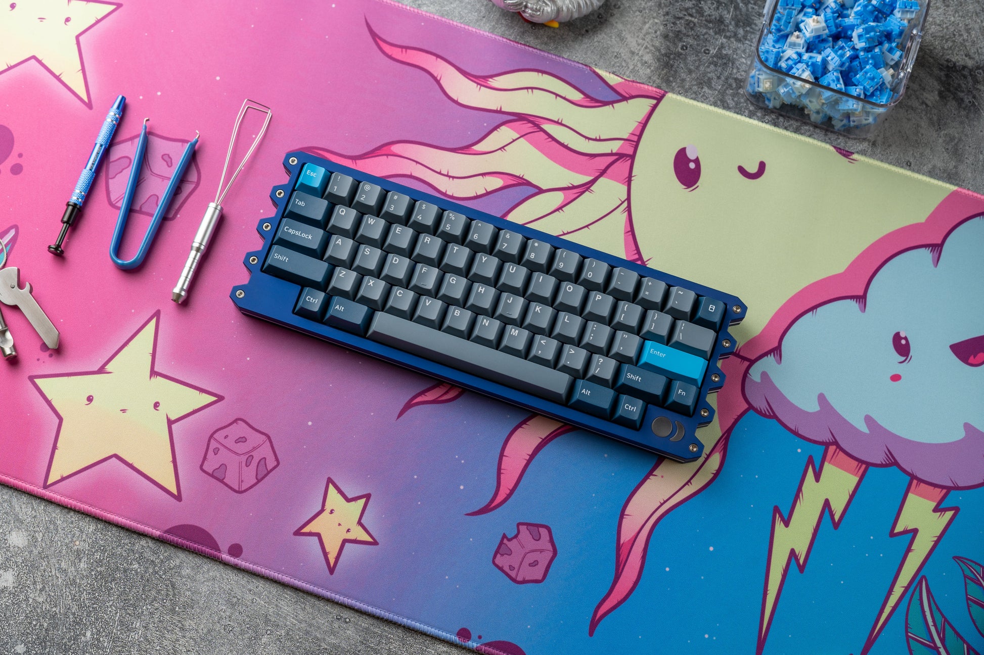 Cartoon desk mat with blue-purple cloud, stars, and keyboard centered on it