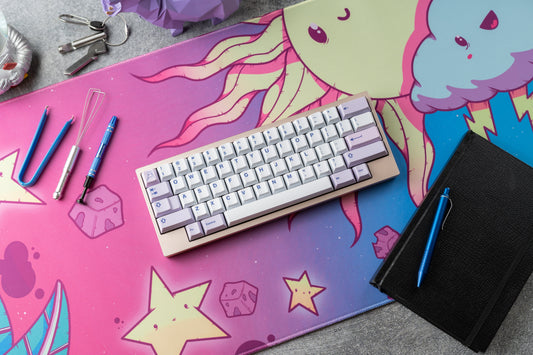 Vibrant cartoon desk mat with cloud character, stars, and keyboard on top