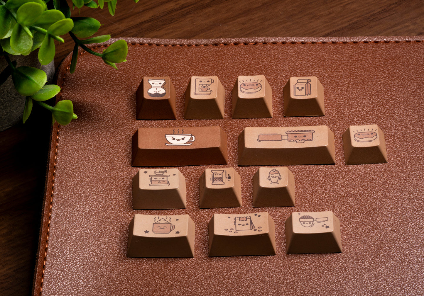 Coffee-themed PBT keycaps close-up on brown surface showing cup and bar icons