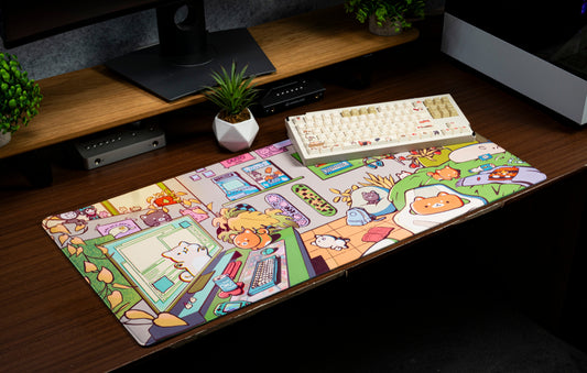 Cartoon character desk mat laid on a wooden desk with keyboard and mouse pads