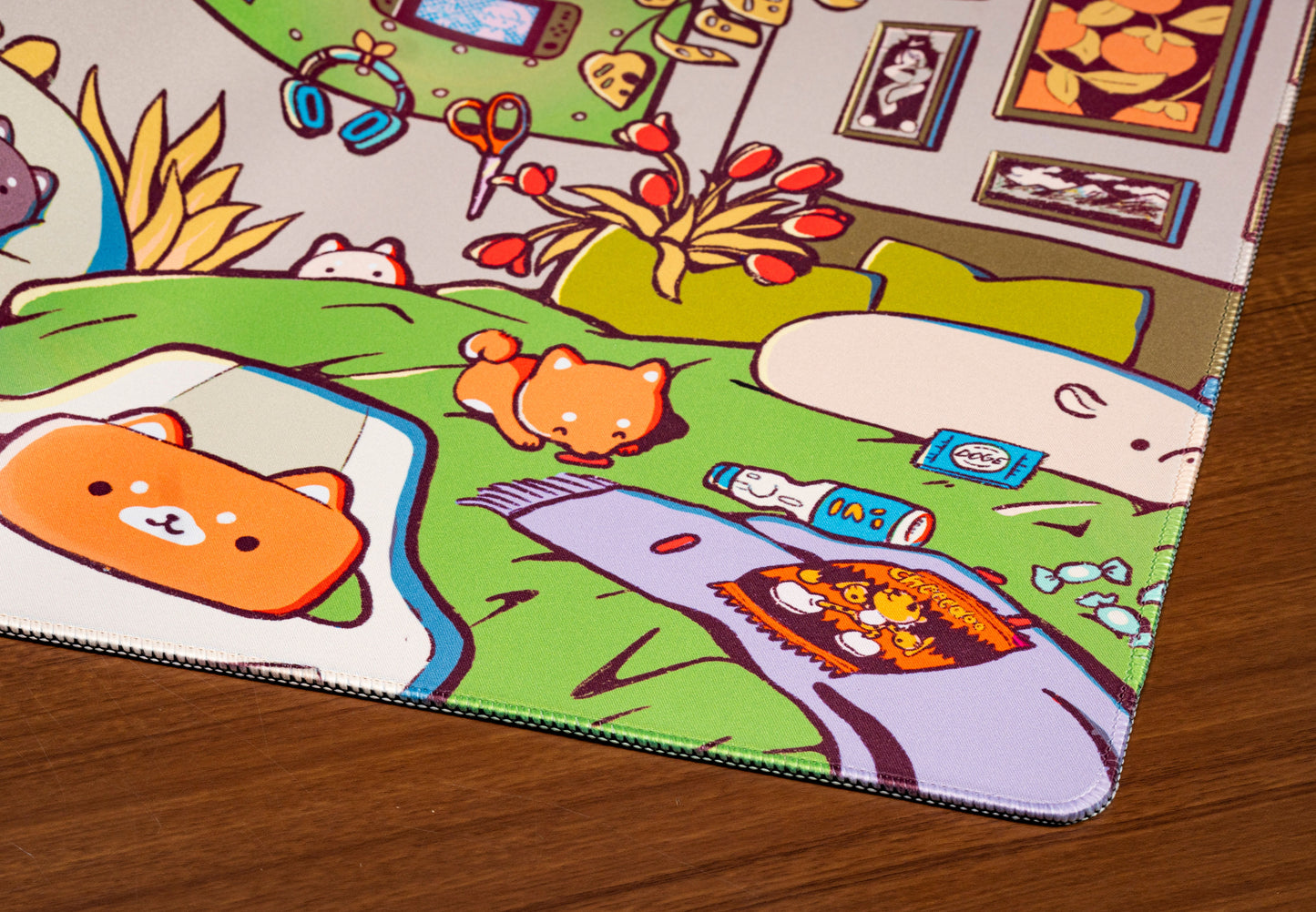 Close-up of cartoon desk mat artwork with green sofa, animals, and office items