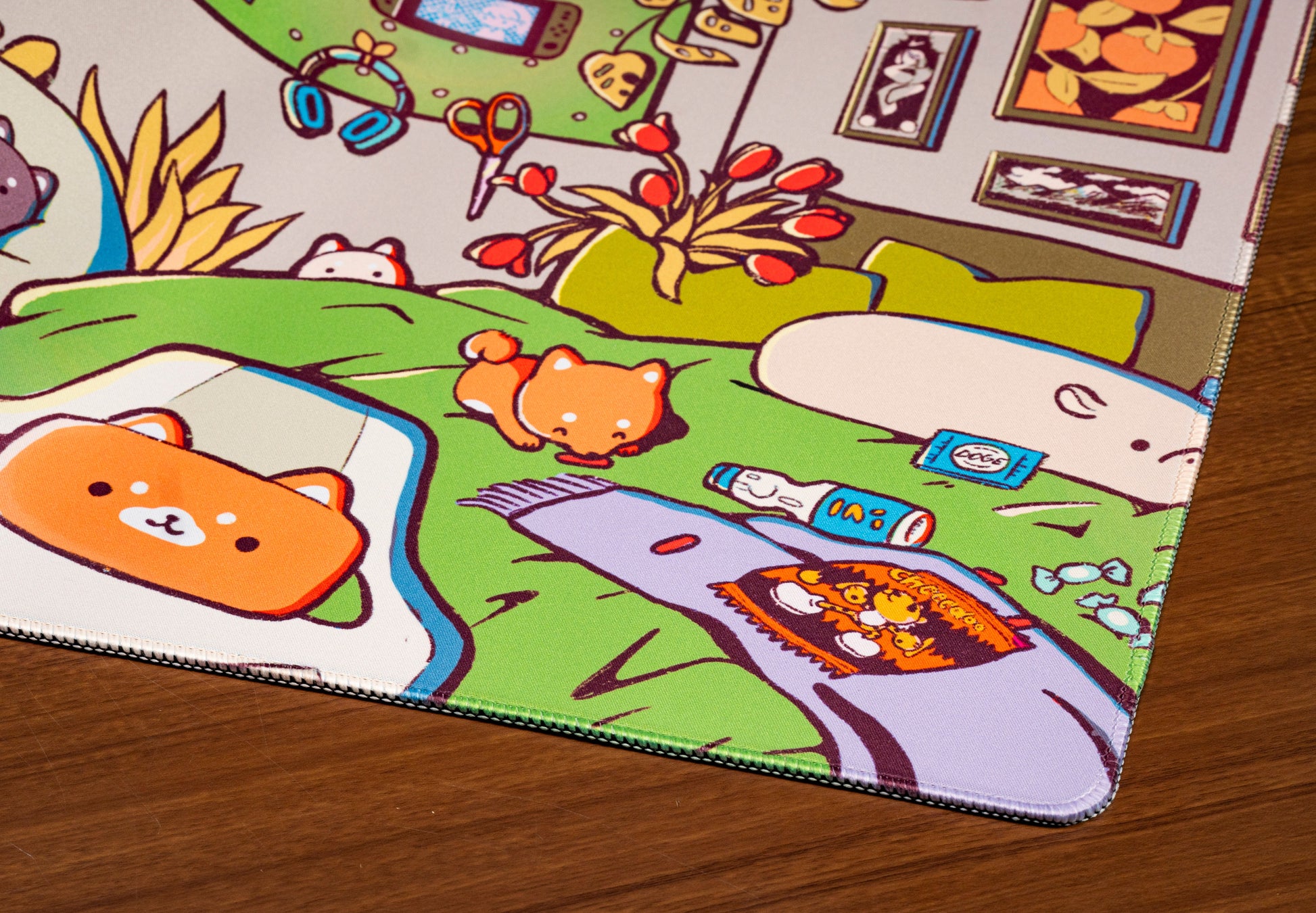 Close-up of cartoon desk mat artwork with green sofa, animals, and office items