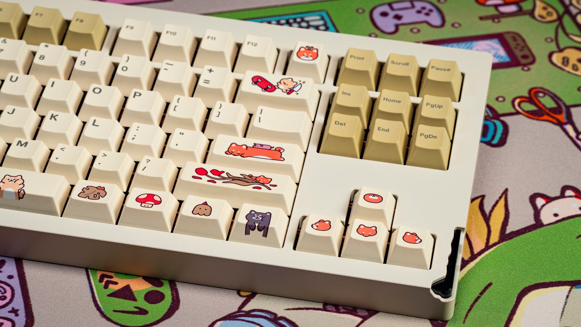 Close-up of cream keycaps with illustrated icons, red and purple accents on some keys