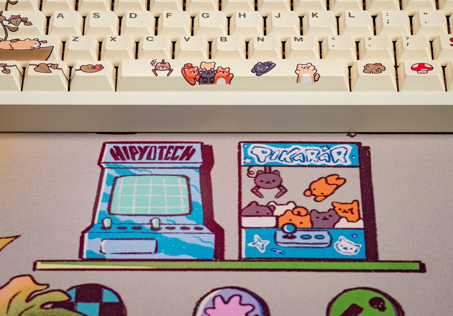 Desk mat close-up featuring game-console and computer-themed cartoon panels