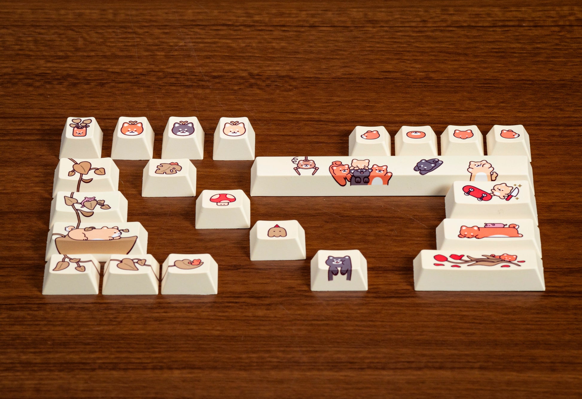 Assorted cream keycaps with animal and food character prints arranged in word-like shape