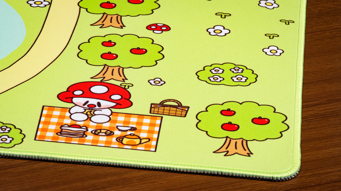 Picnic desk mat close-up of cartoon mushroom tree and picnic basket