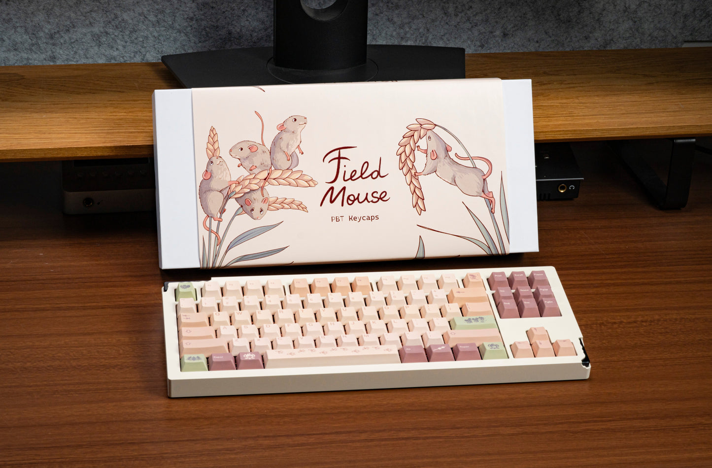 Pastel field mouse themed PBT keycaps in an open box, with mouse art and paw prints