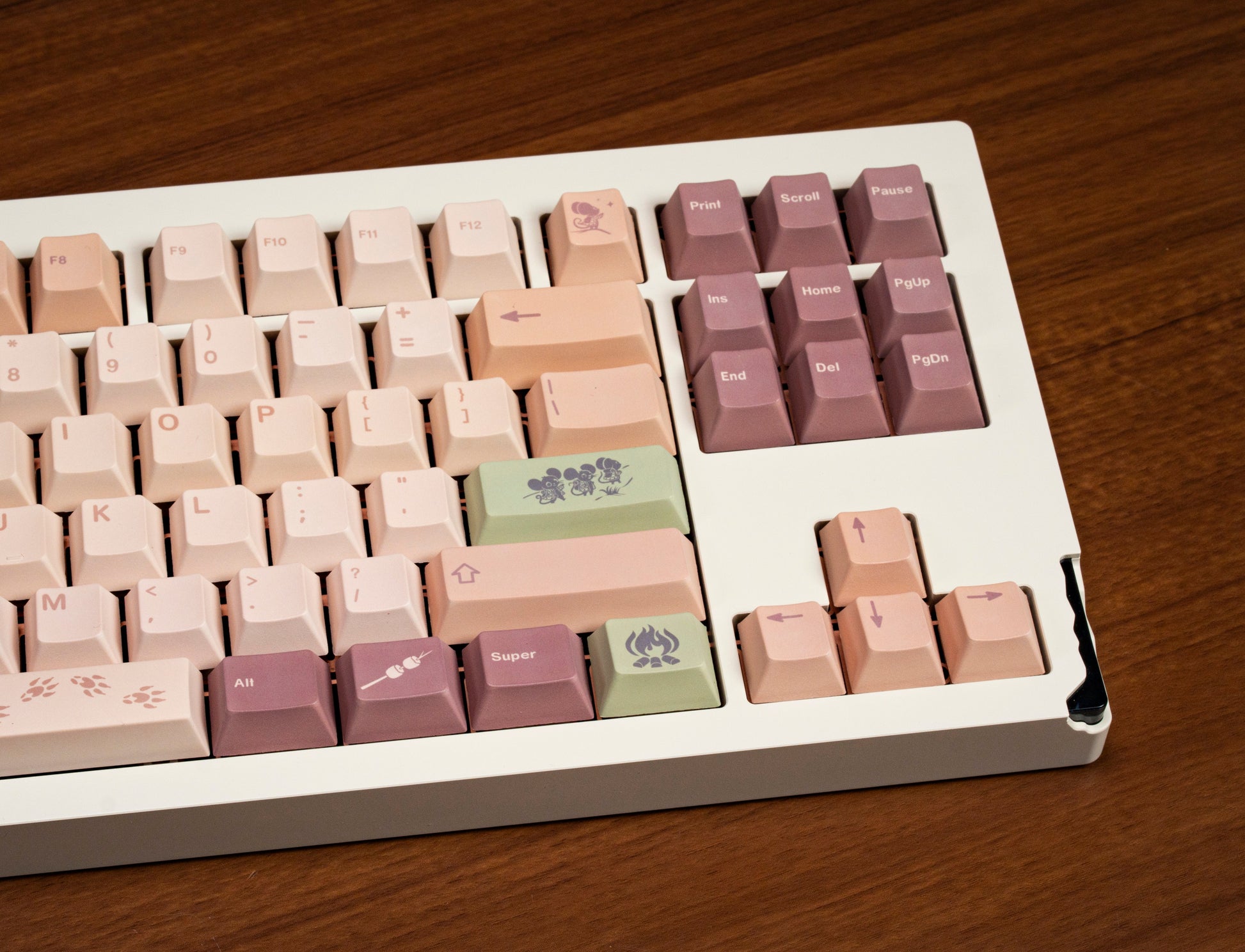 Partially visible field mouse PBT keycaps, pastel cream cluster with purple function keys