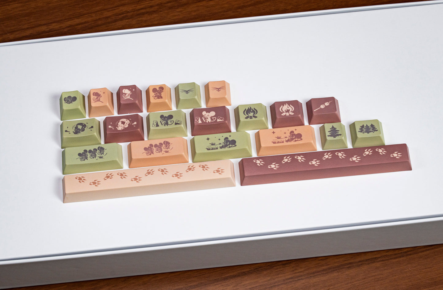 Field mouse PBT keycaps on a tray, pastel spacebar with paw-print design