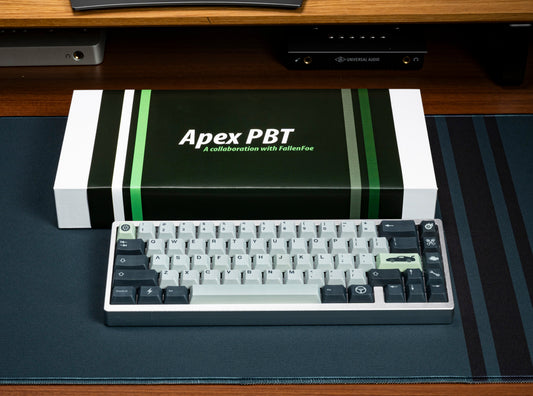 Keycap set box and keyboard with light and dark keycaps, green accent stripes