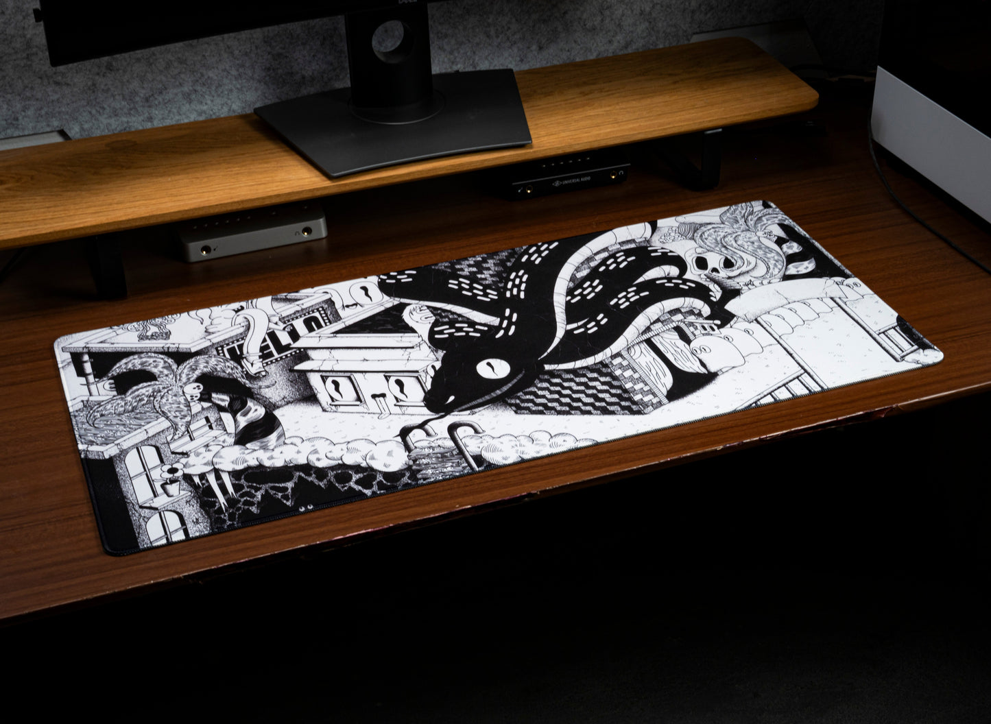 Dead Below desk mat on a desk, featuring swirling tentacle cartoon artwork