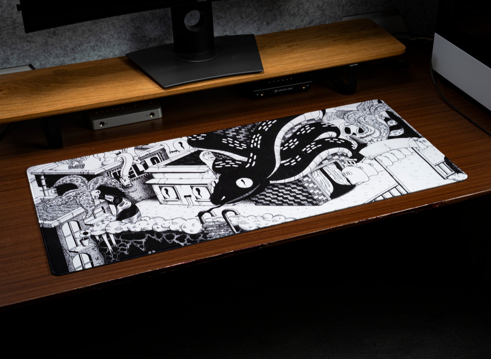 Dead Below desk mat on a desk, featuring swirling tentacle cartoon artwork