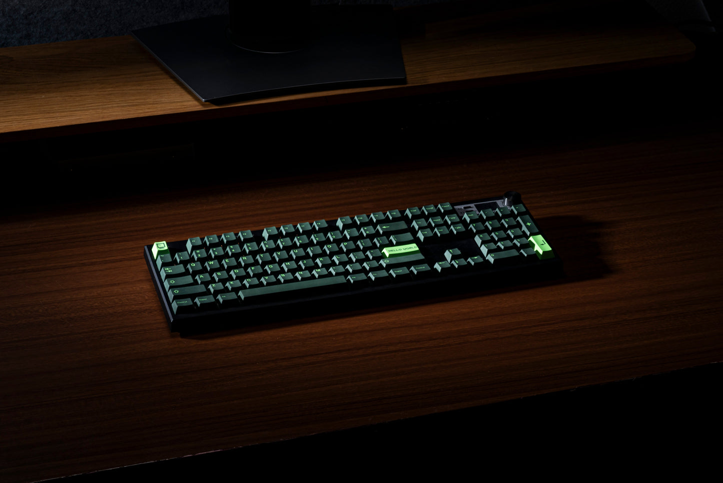 Green and black PBT keycaps with “Hello World” on a compact keyboard layout