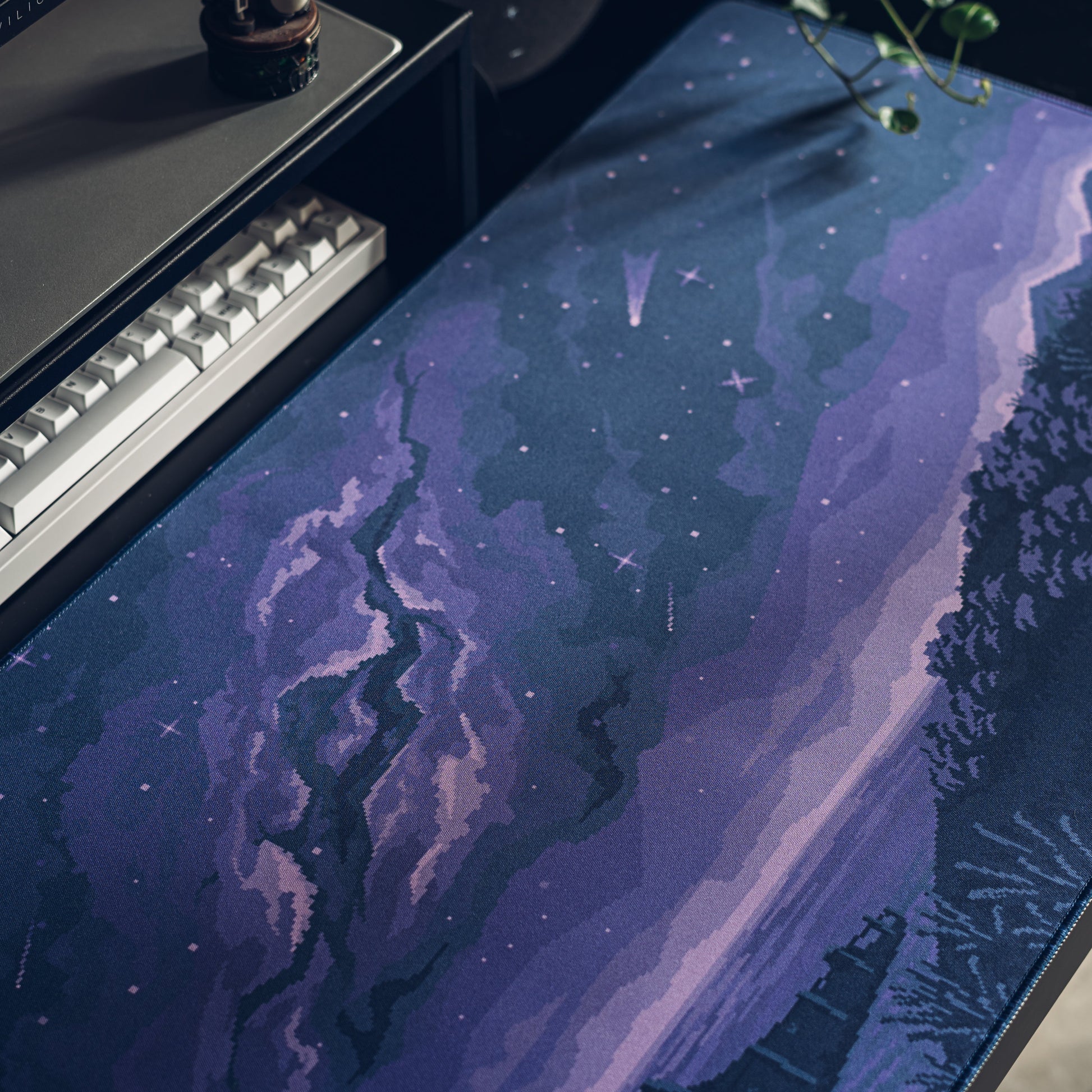 Purple-blue pixel desk mat with scenic path and scattered star motifs