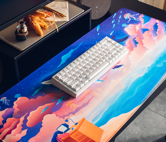 Ocean-themed desk mat with colorful whale and jellyfish illustration in blue and pink