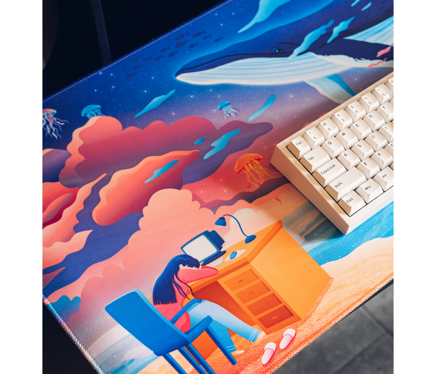 Ocean desk mat featuring an illustrated whale, coral clouds, and jellyfish figures
