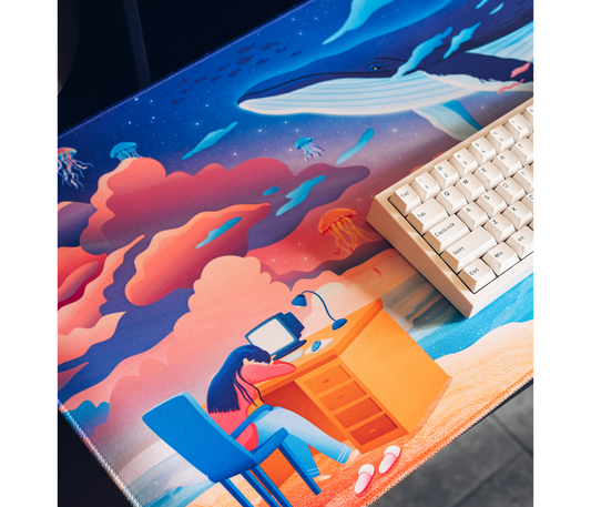 Ocean desk mat featuring an illustrated whale, coral clouds, and jellyfish figures