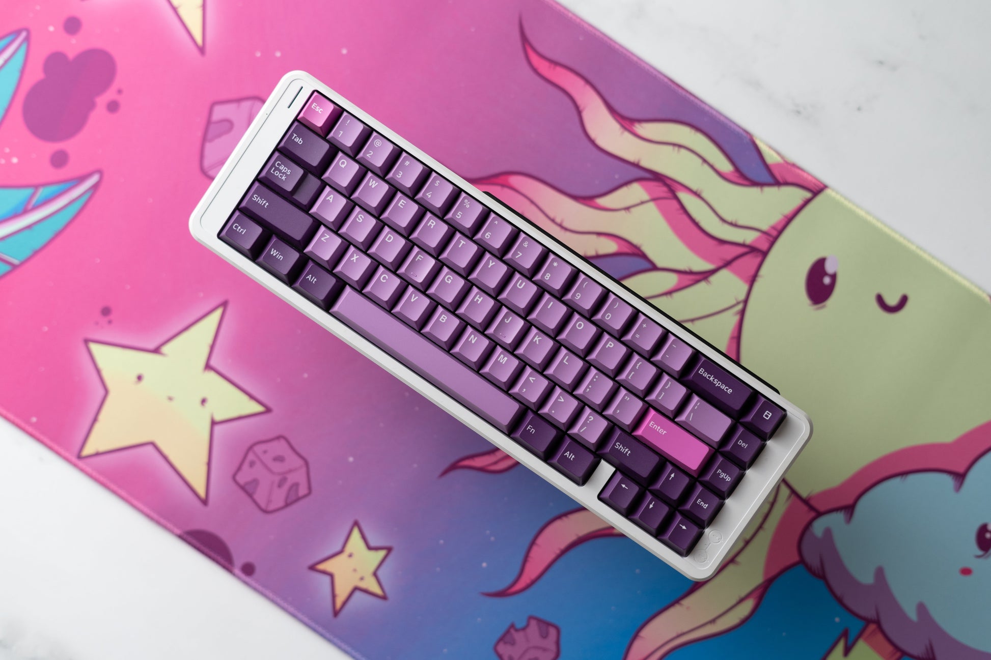 Close-up of cartoon desk mat with cloud character and keyboard keys on top