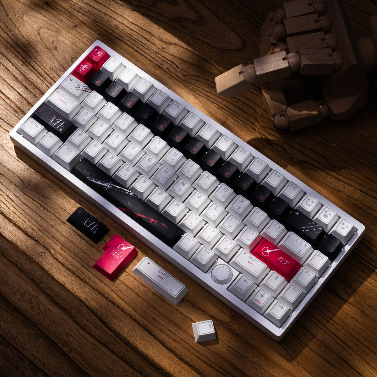 Cherry-profile keycap set with white caps and black accents, scattered loose keycaps