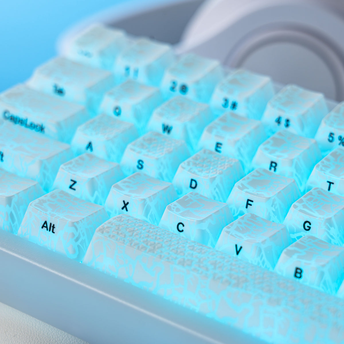 Translucent ice-crack keycaps with blue backlight glow and printed legends