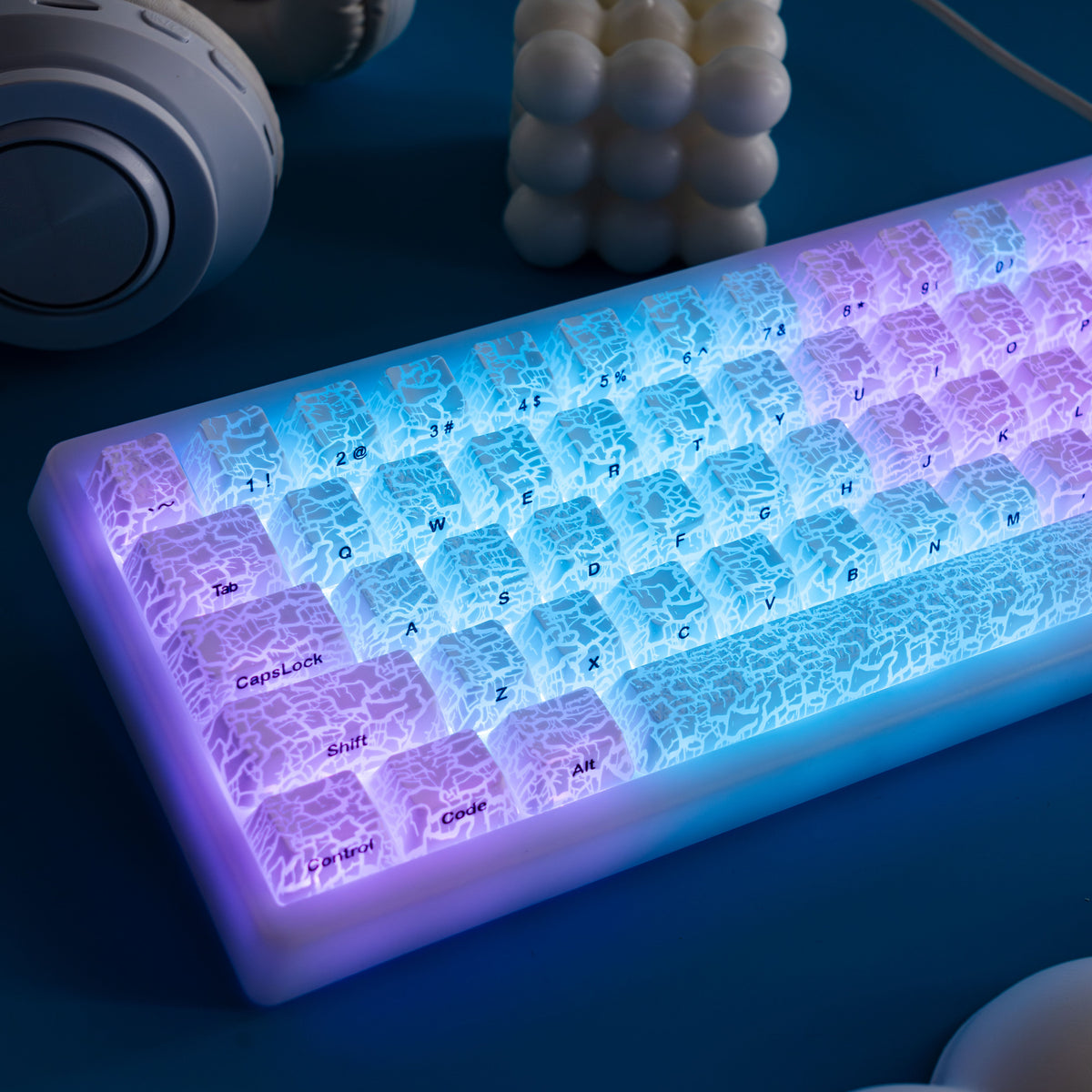 Ice-crack keycap set with shine-through legends under blue-purple glow