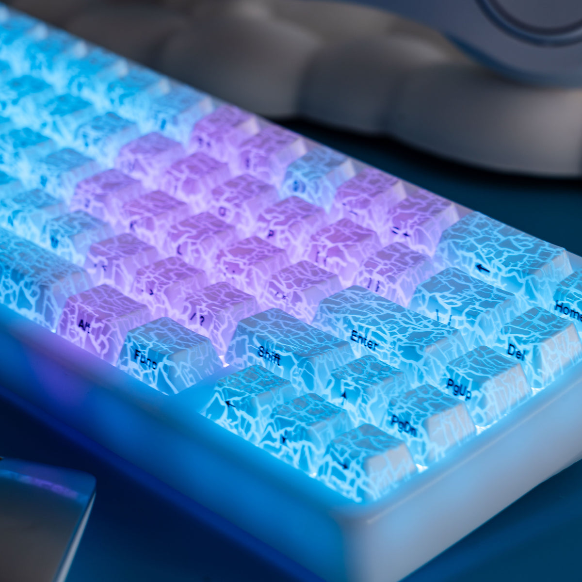 Diagonal view of glowing ice-crack keycaps in blue and purple tones