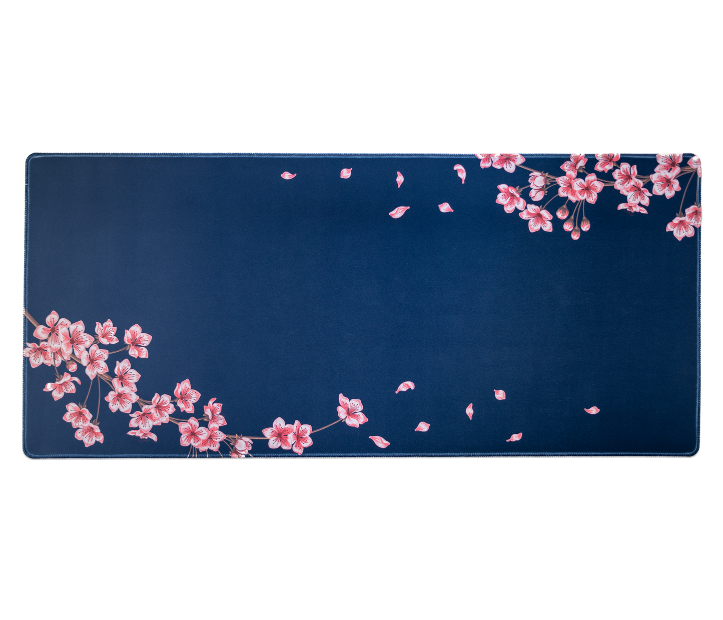 Navy desk mat with pink cherry blossoms and scattered leaf accents; stitched border