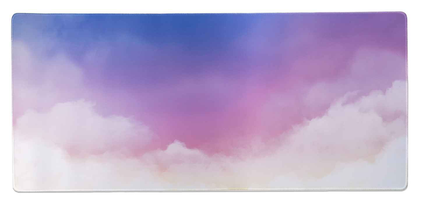 Rectangular desk mat with pastel clouds in blue, purple, and pink with stitched border