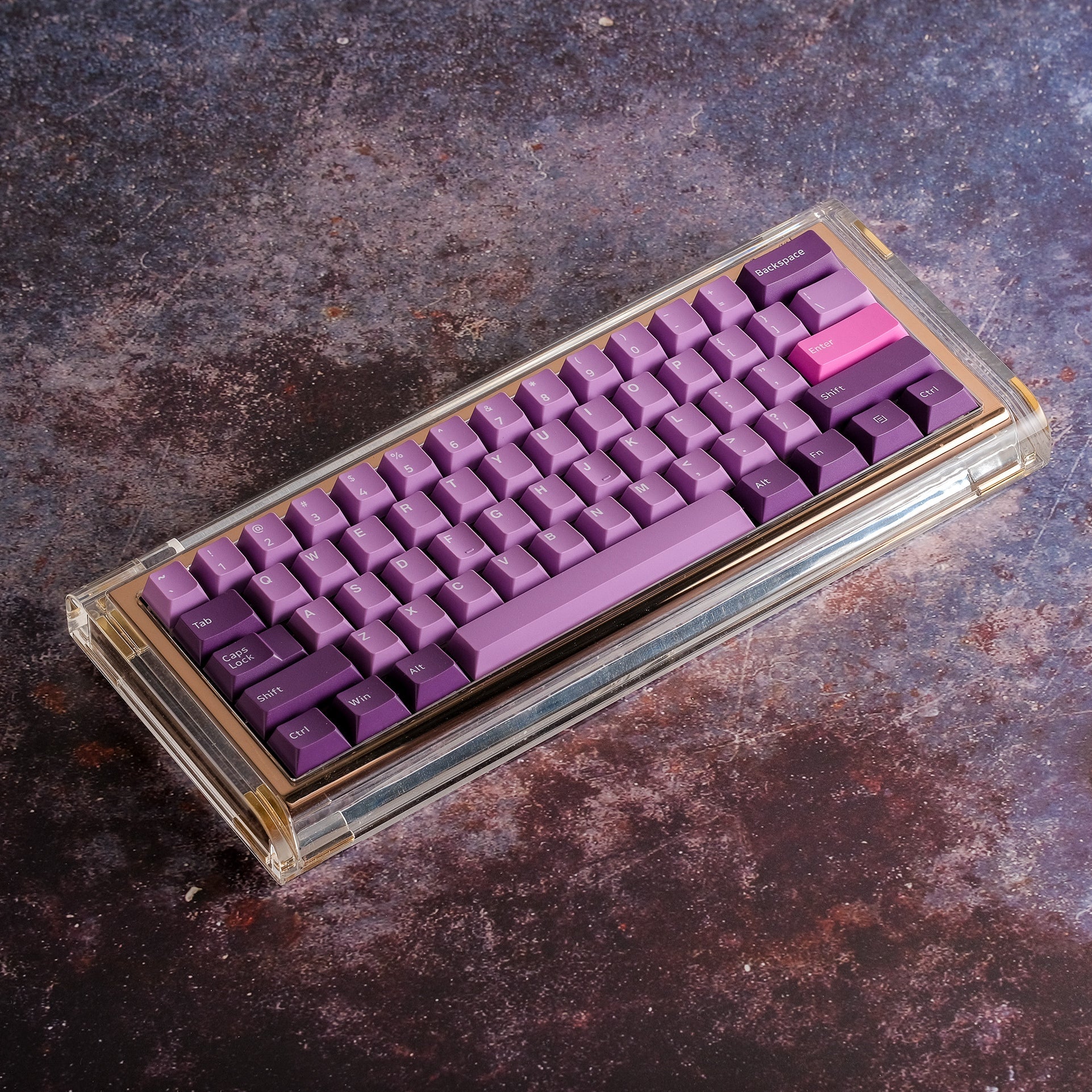 Clear boxed keycap set with purple octopus-themed keycaps and pink accents.