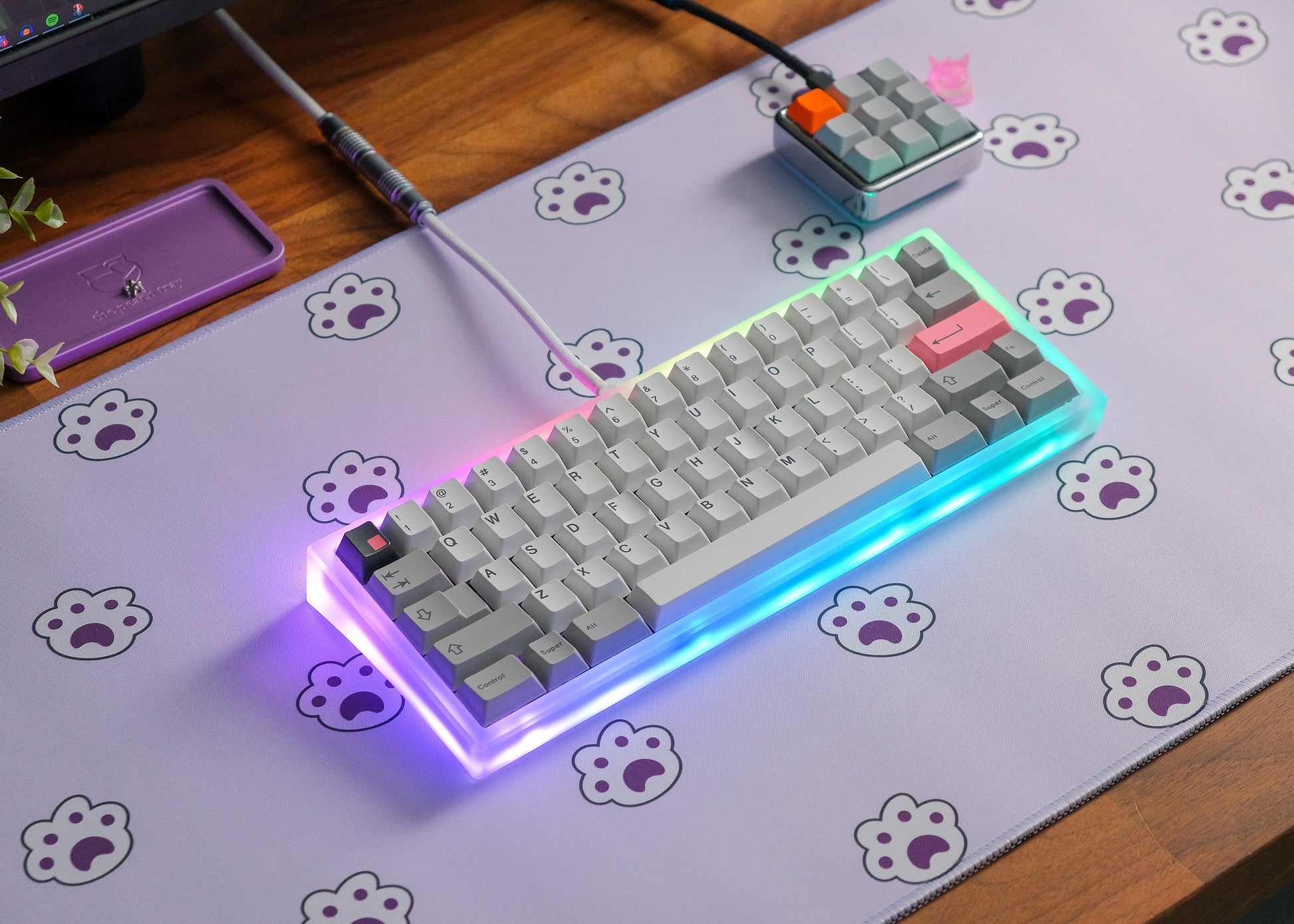 Lavender desk mat with paw-print icons, RGB keyboard glow and cable