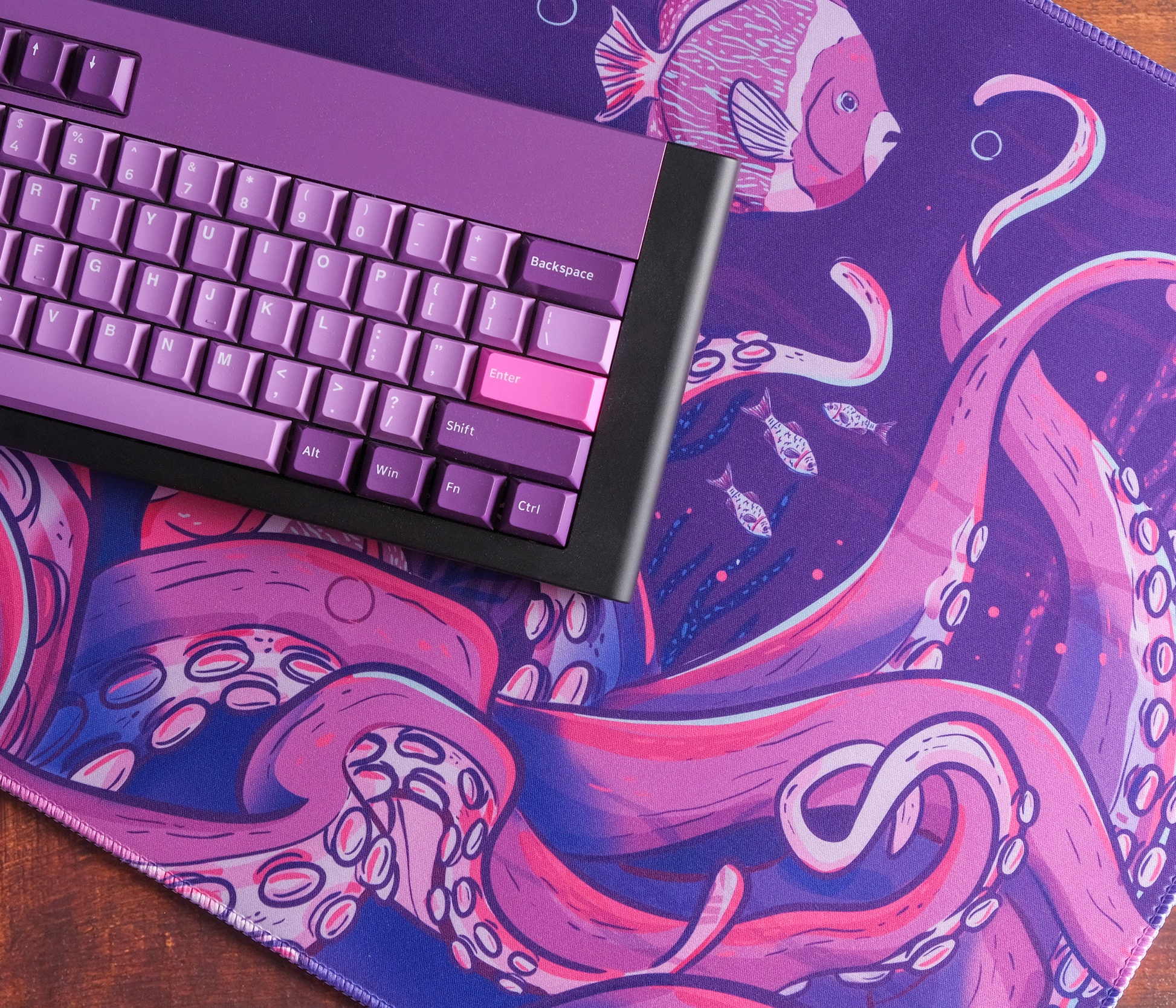 Octopus desk mat with purple underwater artwork and pink accents, stitched edges