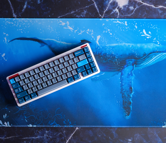 Blue whale desk mat with blue aquatic print and stitched border