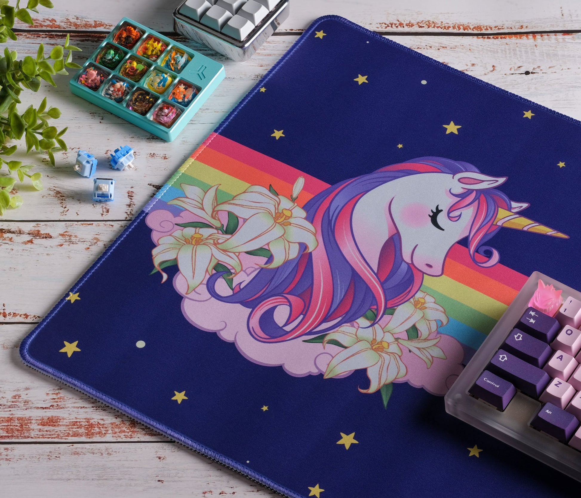 Unicorn desk mat with navy blue background, gold star pattern and rainbow border